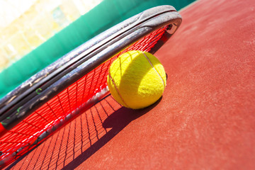 Tennis balls and racket on the grass court