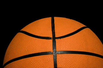 A single basketball isolated on a black background