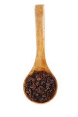 dried barberries in wooden spoon isolated