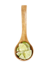 slices of lime in wooden spoon isolated
