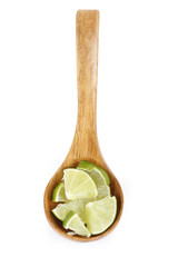 slices of lime in wooden spoon isolated