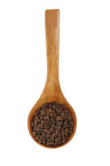 Sichuan peppercorn in wooden spoon isolated
