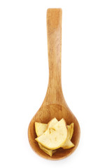 slices of dried apple in wooden spoon isolated