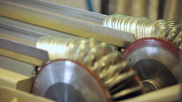 Canning factory conveyor belt. Can lid manufacturing line. Jar lid for canned products on production line. Can manufacturing process. Canning factory manufacturing production