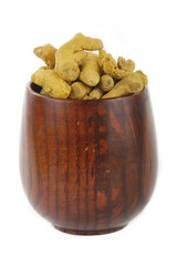 turmeric in wooden cup isolated