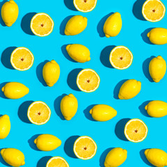 Fresh lemon pattern on a vivid blue background flat lay