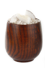 ground cococnuts in wooden cup isolated