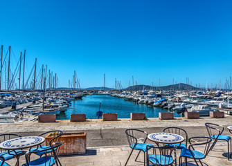 Tables and chairs by Alghero harbor