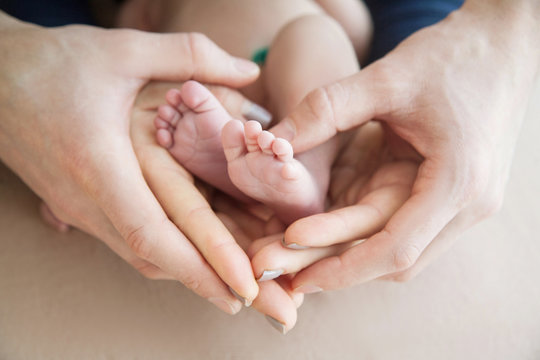 Baby's foot in parents hands