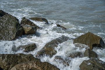 Waves on the coastal stones of the Black Sea, Poti, Georgia