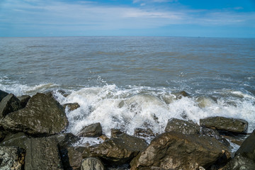 Fototapeta na wymiar Waves on the coastal stones of the Black Sea, Poti, Georgia