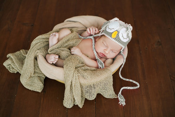 Calm newborn in a cap