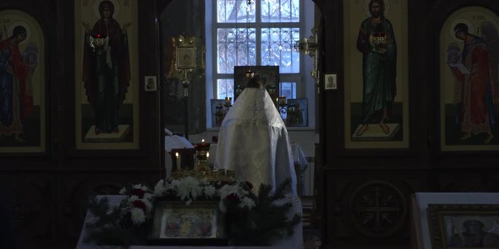Orthodox priest reads prayer together with christians in Russian Church