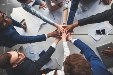 Business team with hands together - teamwork concepts