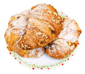 three fresh croissants on plate