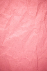 Crumpled recycle pink paper background.