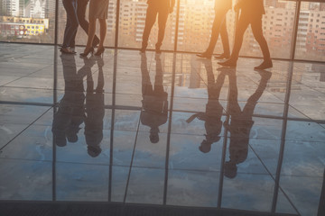 Group of Business People Discussing at Sunset Reflected