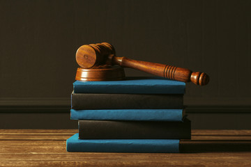 Gavel With Books On Old Wooden Desk
