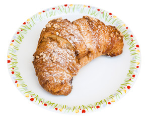 fresh croissant filled by chocolate cream on plate