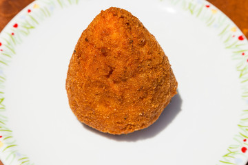 one meat stuffed rice ball arancini on table