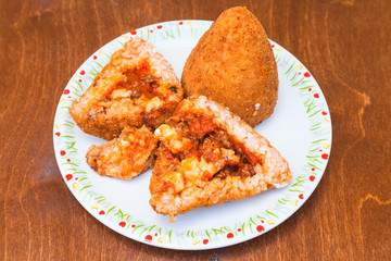 meat ragu stuffed rice balls arancini on table