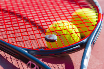 Tennis balls and racket on the grass court