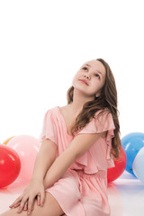 Obraz na płótnie Canvas happy young woman or teenage girl in pink dress with helium air balloons, holidays concept, isolated on white background