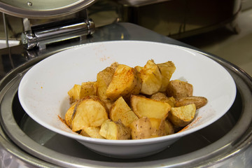 Fried potato wedges with herbs
