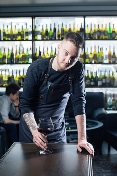 Immersed alcohol critic fixedly gazing at wine