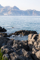 Fototapeta na wymiar rocks on coast of Ionian sea in Giardini Naxos