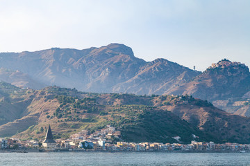 view of Giardini Naxos town in summer sunset