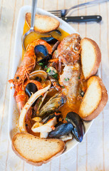 bowl with fish soup in sicilian restaurant