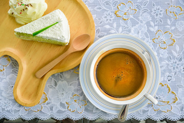 A cup of  coffee and a piece of cake.A cup of coffee. A cup of  Americano coffee. Americano is a...
