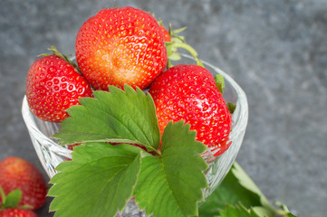 Juicy red strawberries and green leaflets
