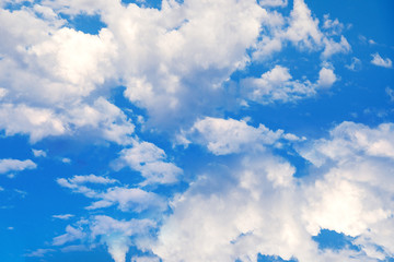 Obraz na płótnie Canvas white clouds on a blue sky. Delicate fluffy white clouds in the sunlight against a blue sky. Spring seamless summer background. Template for design. Light,