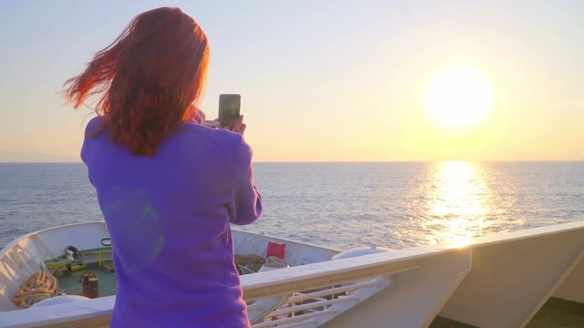 Cruise ship, beautiful woman taking photo of sea sunset, romantic. Happy girl traveling on vacation travel sailing on open sea ocean enjoying romance.