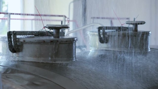 Milk car washing water. Close up of milk truck cleaning water. Dairy truck washing water. Dairy factory processing. Milk processing plant. Dairy truck at processing factory