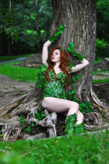 Young beautiful red-haired girl in the image of the comic book poison ivy