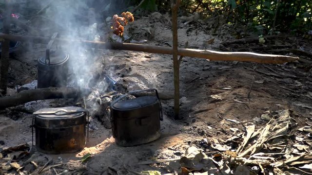 campfire with cooking equipment and smoky