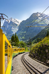Yellow train in Swiss Alps © Jana Ware