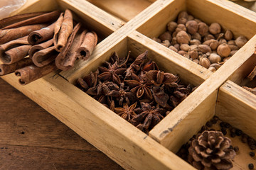 Assorted dried herbs in a printers tray with focus to chamomile flowers and a blend of mixed herbs for use in the kitchen to season and flavour food.