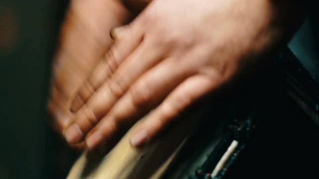 Close up shot of a man hands playing on a Bongo drum. 4k video