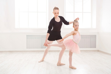 Little girl learn ballet with teacher copy space