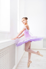 Fototapeta na wymiar Ballet student exercising in ballet costume