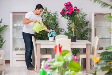 Young man in gardening concept at home
