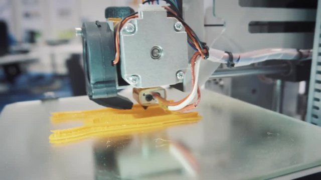 working 3d printer sequence. 3d printer prints a plastic part, maybe a piece of jewelry or an item of art