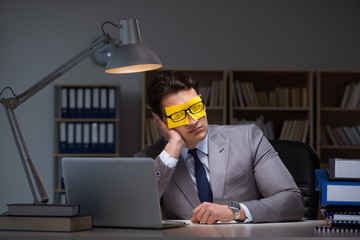 Businessman staying late to sort out priorities