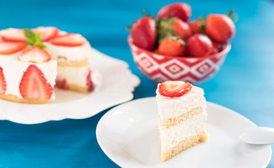 Strawberry cake with sour cream on a blue background top view