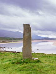 Standing stone with ancient Keltic symbols by the Kyle of Durness at Keoldale, near Durness, Sutherland, Scotland, UK