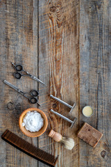 Barbershop. Men's shaving and haircut. Brush, razor, foam, sciccors on wooden table background top view copyspace